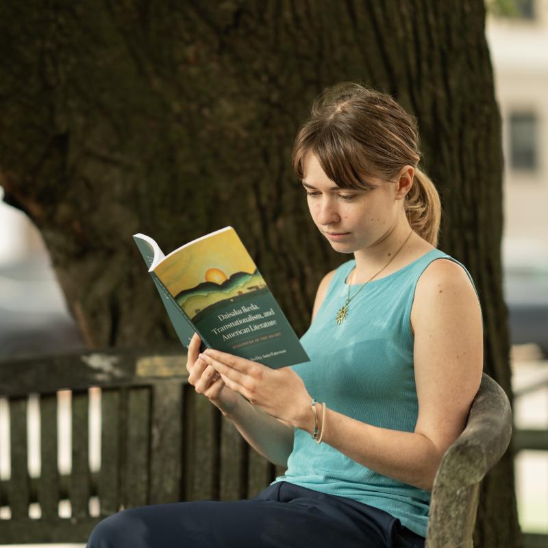 Ikeda Center program intern Becca reading Dialogues of the Heart