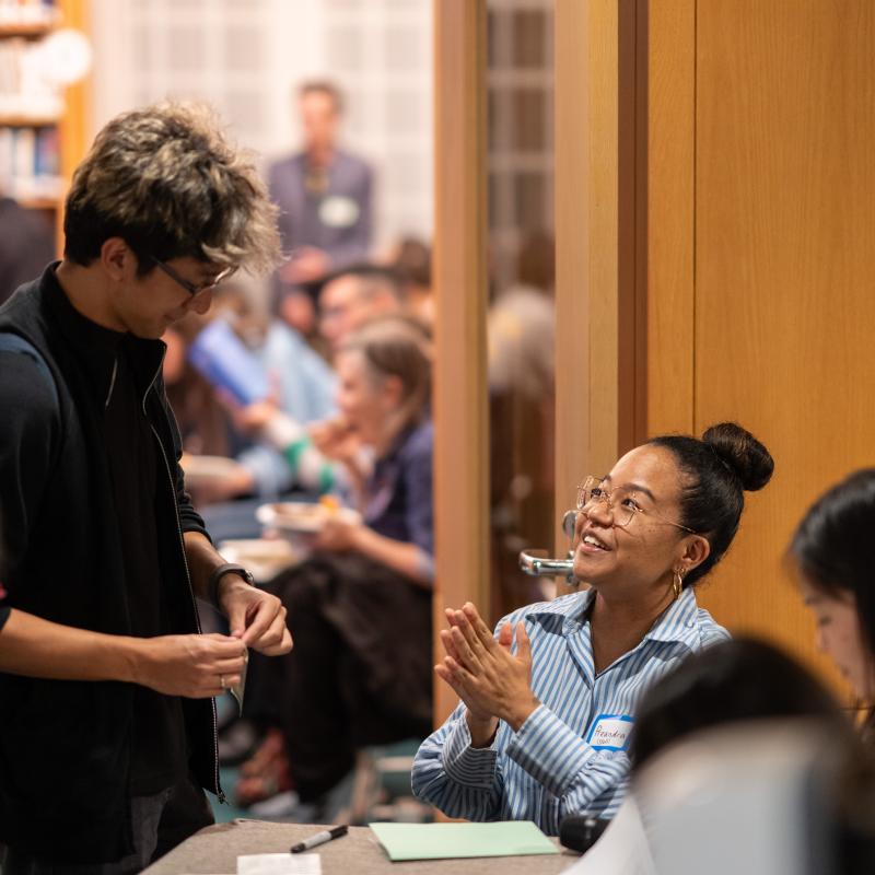 Ikeda Center staff greeting attendees at the 2026 Ikeda Forum