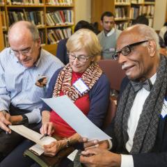 Three participants engaging in dialogue at the 2018 Ikeda Forum