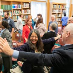 Anita Patterson participating in movement activity at the 2023 Ikeda Forum