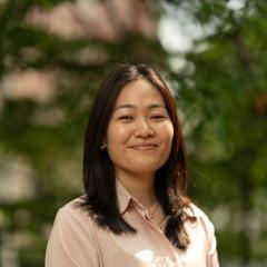 Headshot image of staff with greenery background