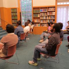 Center staff Preandra welcomes participants to Dialogue Nights