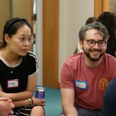 Three participants engaging in small group dialogue
