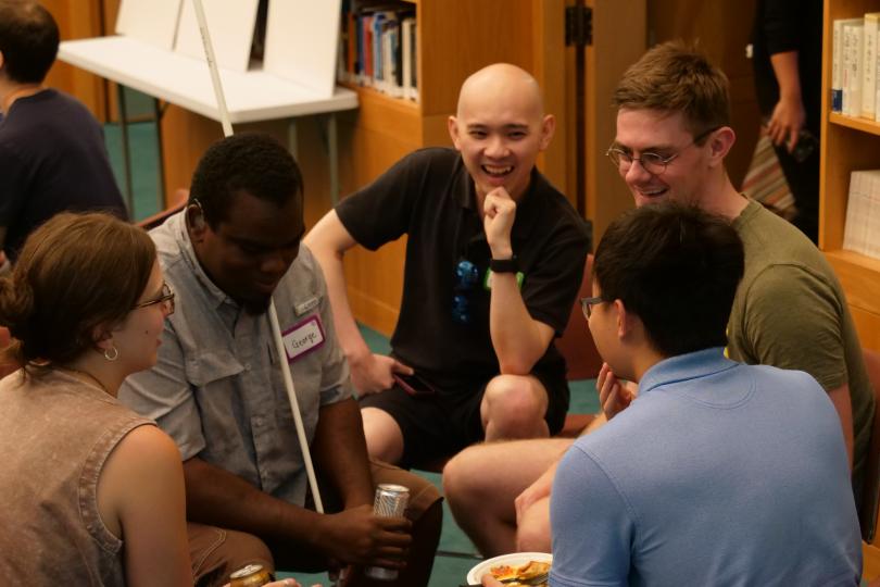 Five participants engaging in small group dialogue