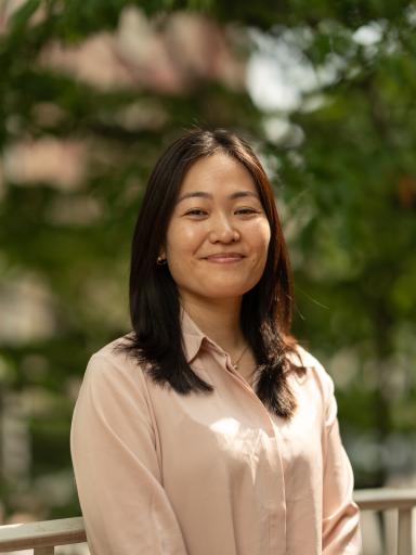 Headshot image of staff with greenery background