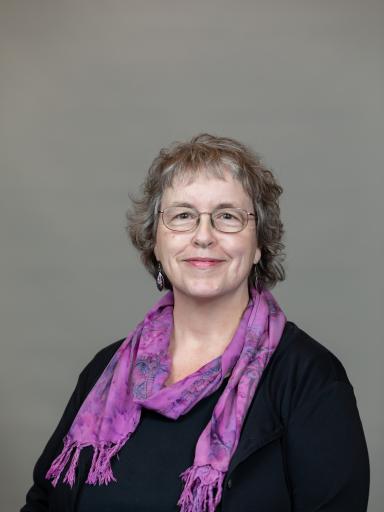 Headshot of staff with grey background