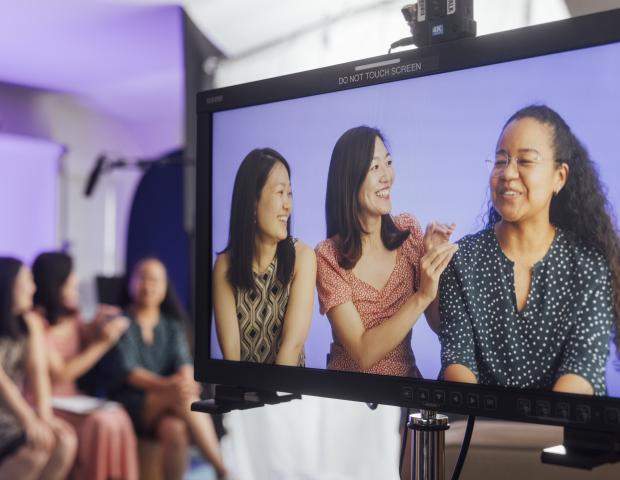 Action shot of three staff members during the filming of our intro video