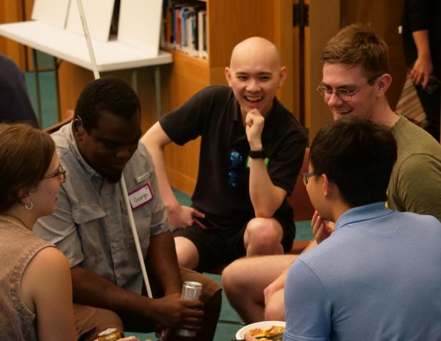 Five participants engaging in small group dialogue