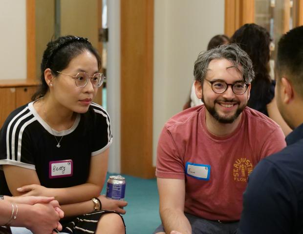 Three participants engaging in small group dialogue
