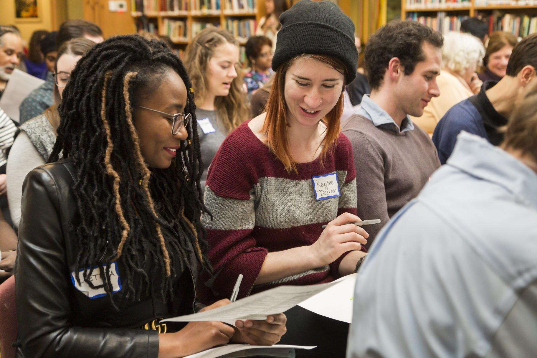 Two participants engage in dialogue at the 2018 Ikeda Forum