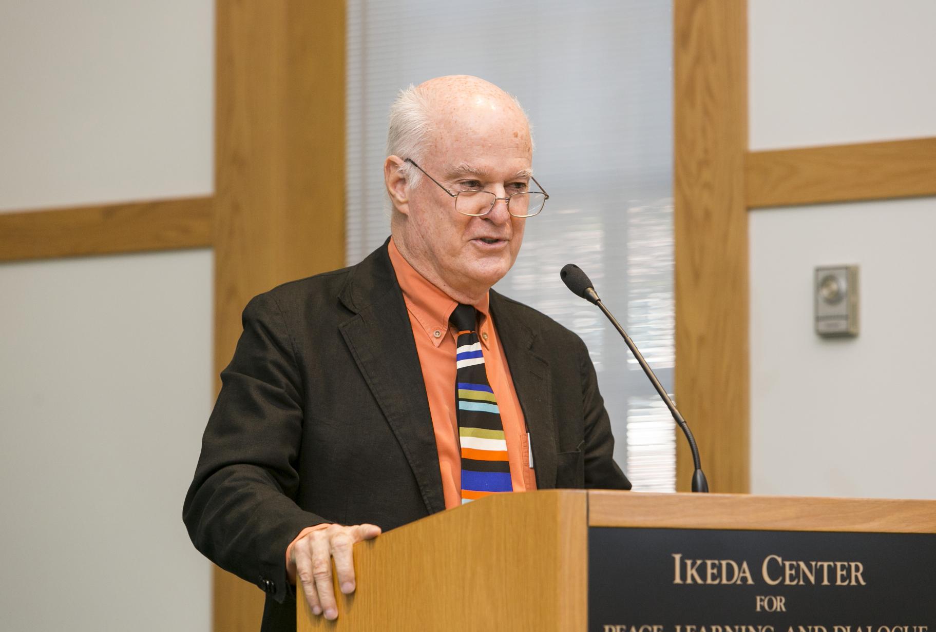 2014 Ikeda Forum speaker Charlie Clements speaking at the podium