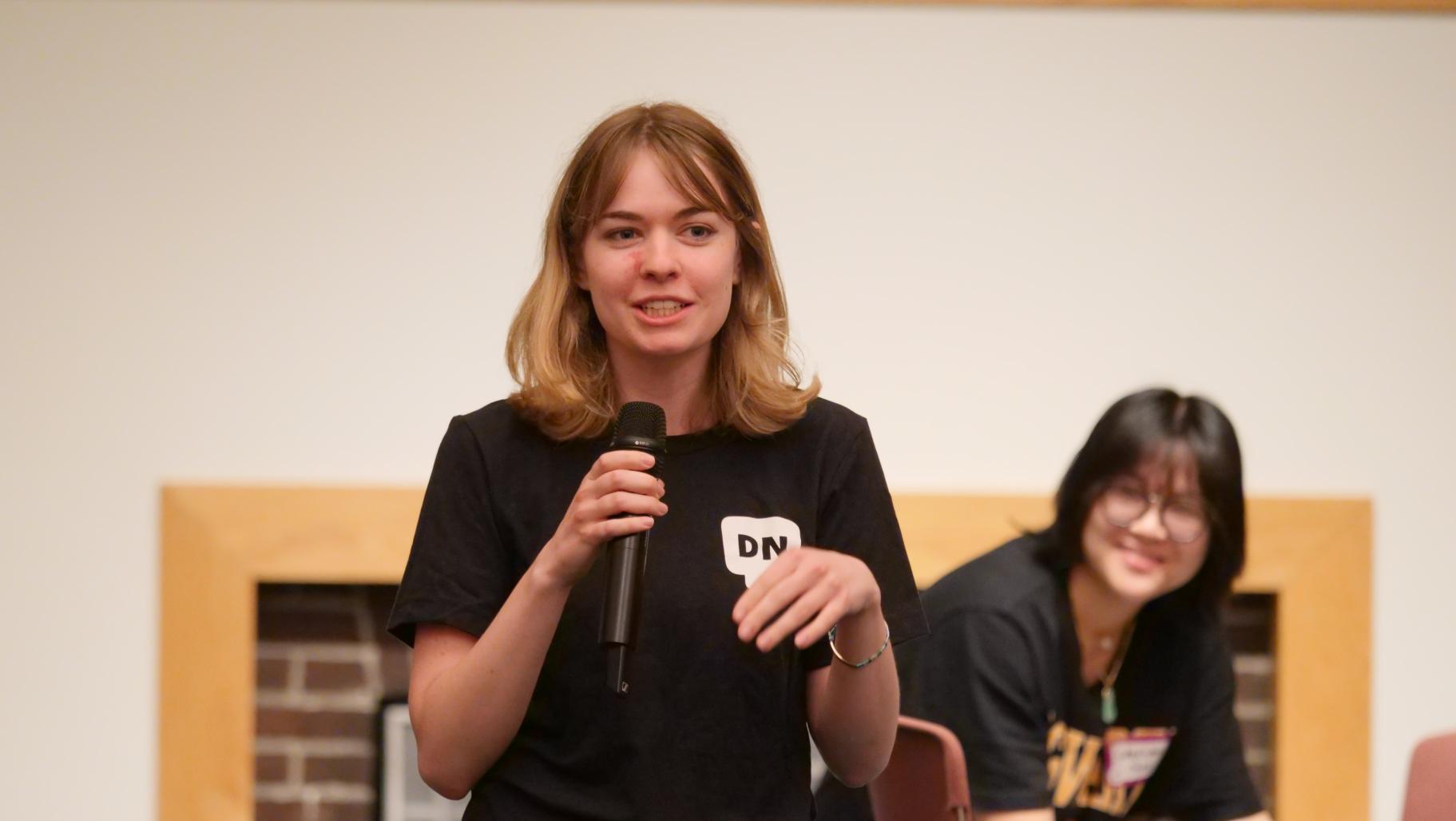 Program intern Becca Faber speaking at June 2026 Dialogue Nights Lite