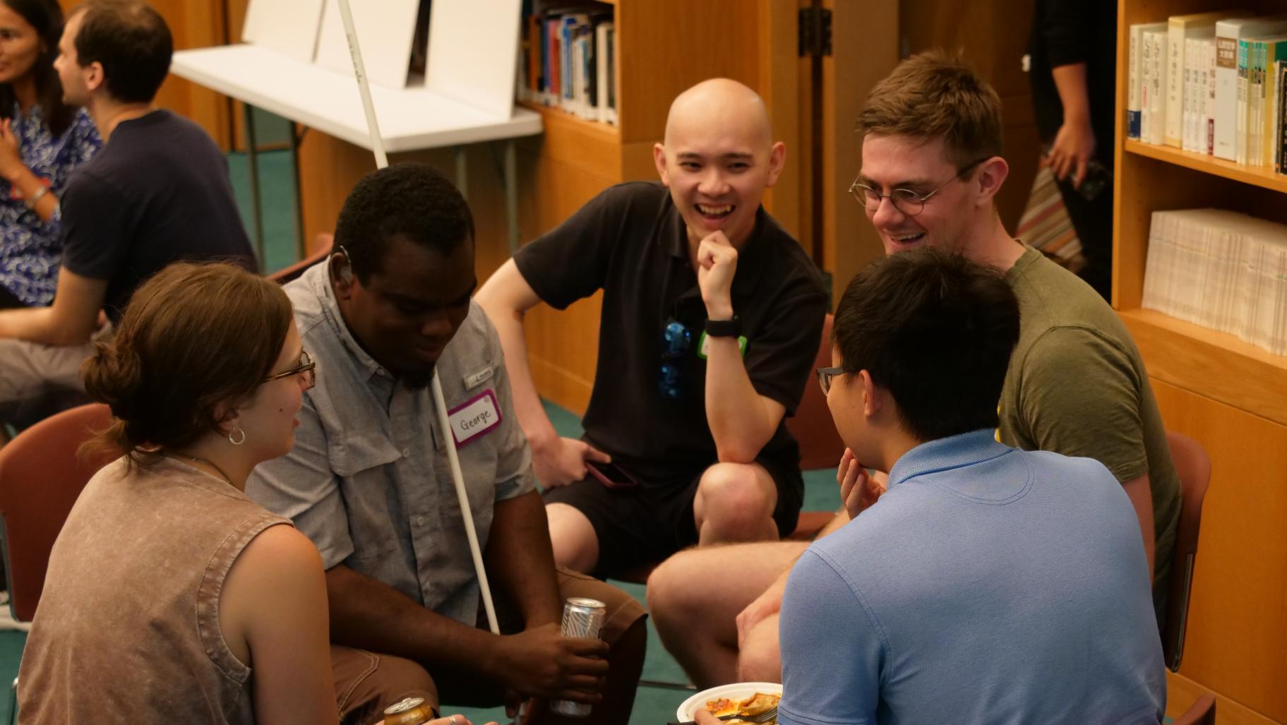 Five participants engaging in small group dialogue